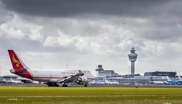 This file photo taken on March 2, 2016 shows a Yangtze River Express plane next to the control tower at Schiphol Airport in Amsterdam. Amsterdamu2019s rapidly-growing Schiphol airport is reaching its limits for the safe movement of planes on its busy airstrips, the Dutch safety watchdog has warned, saying that runway risks needed to be addressed before any further expansion.