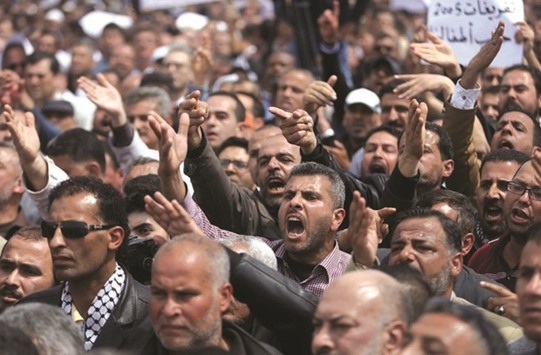 Palestinian Authority employees take part in a protest against what they say are deductions on their salaries, in Gaza City yesterday.