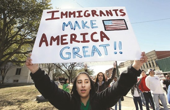Flashback: A high school student holds up a sign as she protests with others outside the Grayson County courthouse in downtown Sherman, Texas, on Feb. 16, 2017. In an action called u201cA Day Without Immigrants,u201d immigrants across the country stayed home from school, work and closed businesses to show how critical they are to the US economy and way of life.