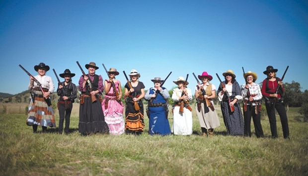 Women and girls pose for a picture with their firearms before competition at the Women of the West shooting competition at the Namoi Pistol Club in Gunnedah in rural New South Wales, Australia.