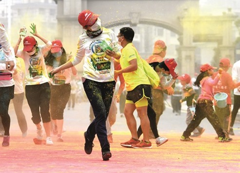 People take part in a u2018Colour Runu2019 in Xinyu City in east Chinau2019s Jiangxi Province yesterday.
