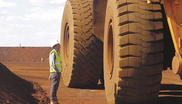 A worker checks a truck loaded with iron ore at the Fortescue Metals Groupu2019s iron ore mine located south of Port Hedland in the Pilbara region of Western Australia. The worldu2019s fourth-biggest exporteru2019s mines in northwestern Australia are well-positioned to take advantage of expected growth in countries such as India, Vietnam and thePhilippines, chief financial officer Elizabeth Gaines said in an interview.