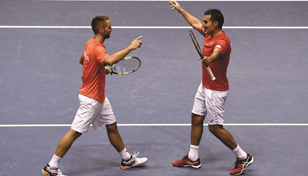 Serbiau2019s Nenad Zimonjic (R) and Viktor Troicki celebrate their victory after the Davis Cup quarter-final doubles.