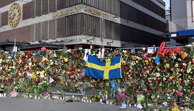 Flowers are seen on Sunday near a store following Friday's attack in Stockholm.