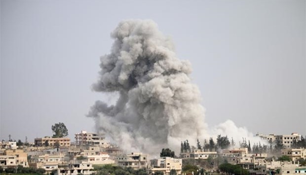 Smoke billows following a reported air strike on a rebel-held area in the southern Syrian city of Deraa.