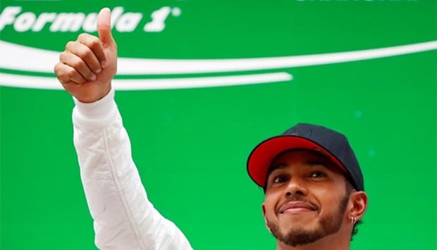 Mercedes driver Lewis Hamilton of Britain celebrates on the podium after winning the Chinese Grand Prix in Shanghai on Sunday.