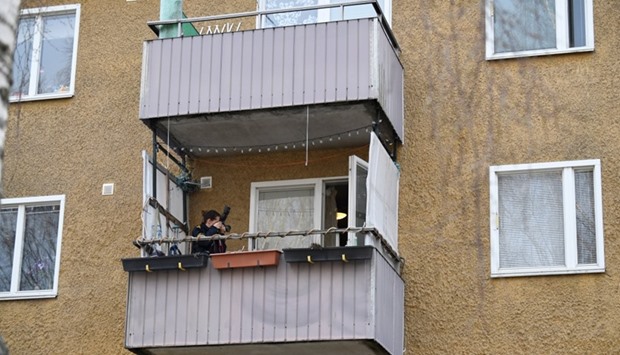 A police photographer takes pictures during a house search in an apartment in Varberg south west of Stockholm, Sweden.