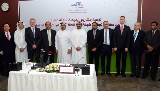 HE the Minister of Energy and Industry Dr Mohamed bin Saleh al-Sada and Kahramaa president Essa bin Hilal al-Kuwari with representatives of the companies which were awarded contracts. PICTURE: Thajudeen.