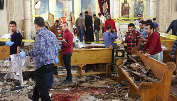 A general view shows forensics collecting evidence at the site of a bomb blast which struck worshippers gathering to celebrate Palm Sunday at the Mar Girgis Coptic Church in the Nile Delta City of Tanta