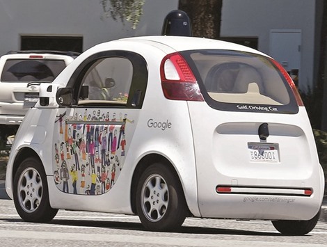 HIGH STAKES: A Google self-driving car moves along the roadway at the companyu2019s headquarters in Mountain View, California.