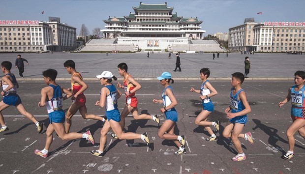 Competitors run through Kim Il-sung square in central Pyongyang.
