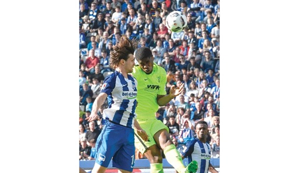 Berlinu2019s Valentin Stocker (left) and Augsburgu2019s Kevin Danso vie for the ball during the Bundesliga match yesterday. (AFP)
