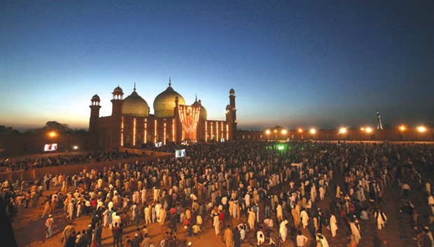 People greet one another after evening prayers led by Sheikh Saleh bin Ibrahim Imam Qaba at the Badshahi Mosque in Lahore yesterday.