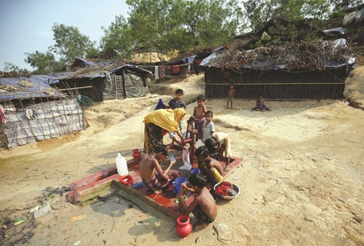 Rohingya refugees bathe and collect water from a tube-well at Balukhali Makeshift Refugee Camp in Coxu2019s Bazar, Bangladesh.