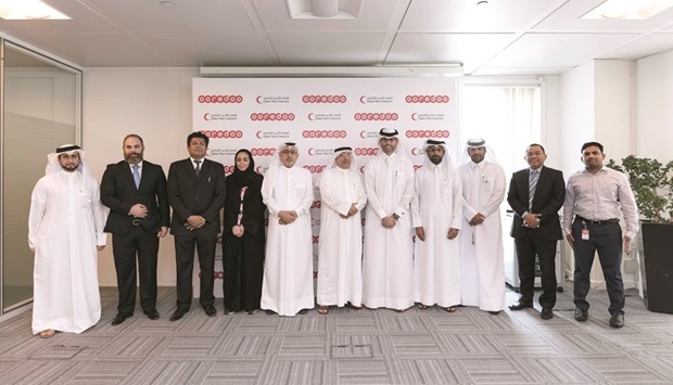 Ooredoo and QRCS officials at the agreement signing ceremony.