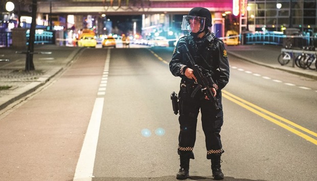 A police officer stands guard near an area in central Oslo that has been cordened off late on Saturday after police arrested a man following the discovery of a u2018bomb-like deviceu2019.