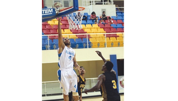 Al Gharafau2019s Saad Abdulrahman (left) in action during the match against Qatar SC yesterday. Abdulrahman scored 23 points in his teamu2019s win. PICTURE: Othman Iraqi