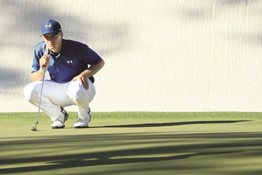 Jordan Spieth of the United States lines up a putt on the 16th green.
