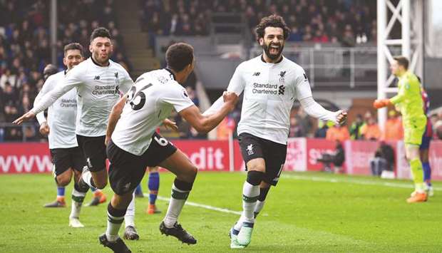 Liverpoolu2019s Mohamed Salah (right) celebrates with team mates after scoring the winner against Crystal Palace during the Premier League in London. (Reuters)