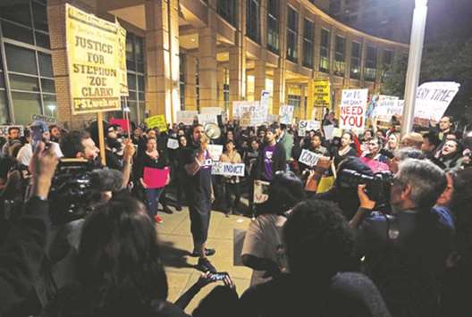 Demonstrators gather outside City Hall to protest the police shooting of Stephon Clark, in Sacramento, California, on Friday night.