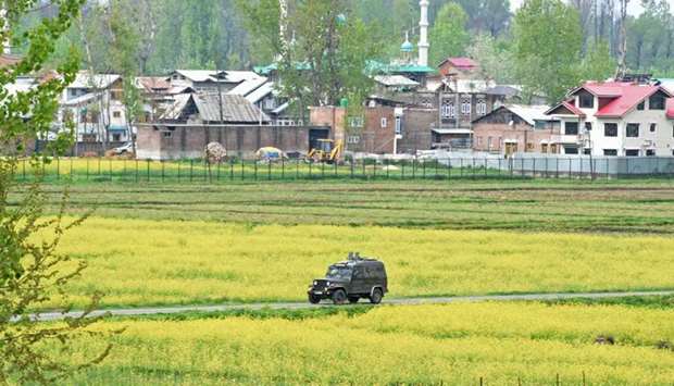 An Indian army vehicle patrols near the site of a gun battle took place between Indian government forces and rebels at Khudwani area of Kulgam, south of Srinagar.