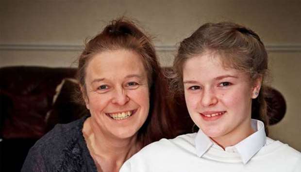 Amelia Thompson, 12, who was caught in the bombing at the Manchester Arena, and has received an invitation to the wedding of Britain's Prince Harry and Meghan Markle at Windsor Castle next month, poses for a portrait with her mother Lisa Newton at their home in Sheffield.