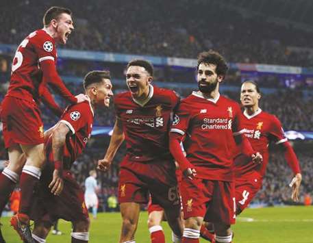 Liverpoolu2019s Mohamed Salah (second right) celebrates with teammates after scoring against Manchester City in the Champions League quarter-final on Tuesday. (Reuters)