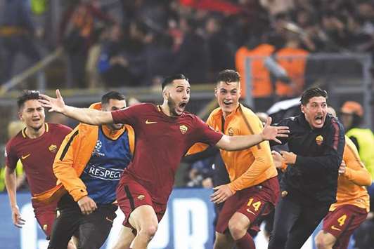 AS Romau2019s Greek defender Kostas Manolas (centre) is ecstatic after scoring a goal during the UEFA Champions League quarter-final second leg match against FC Barcelona at the Olympic Stadium in Rome on Tuesday night. Roma won 3-0, to over-turn a 4-1 quarter-final deficit and eliminate Barca on away goals. (AFP)