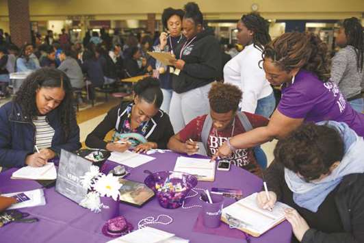 Students at South Cobb High School in Atlanta carefully double-check the details on their driveru2019s licences and permits as they register to vote during a registration drive by voting rights group New Project Georgia in Austell, Georgia.
