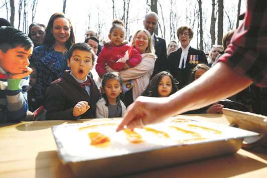 New Canadian citizen David Alfonso, 8, reacts as maple taffy is prepared for new Canadians following a citizenship ceremony at the Vanier Sugar Shack in Ottawa on Tuesday.