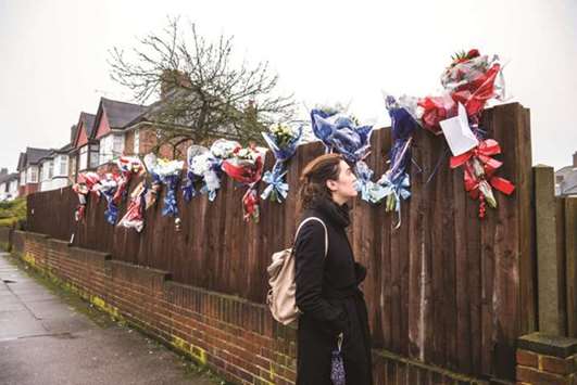 A woman looks at the floral tributes for Henry Vincent in Hither Green yesterday.