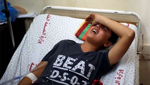 A young Palestinian who was wounded at the Israel-Gaza border reacts at al-Shifa hospital in Gaza City on Sunday.