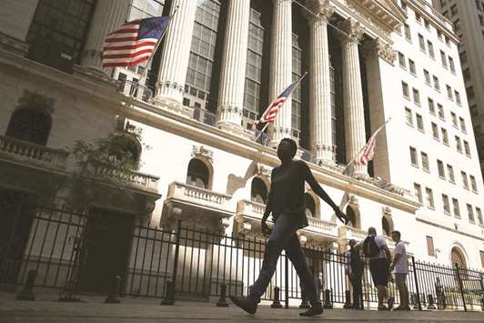 People walk by the New York Stock Exchange (file). The US stock futures, including contracts for the Nasdaq, turned positive last week as tech fears began to ease.