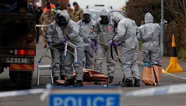 British military personnel wearing protective coveralls work to remove a vehicle connected to the March 4 nerve agent attack in Salisbury last month. File picture