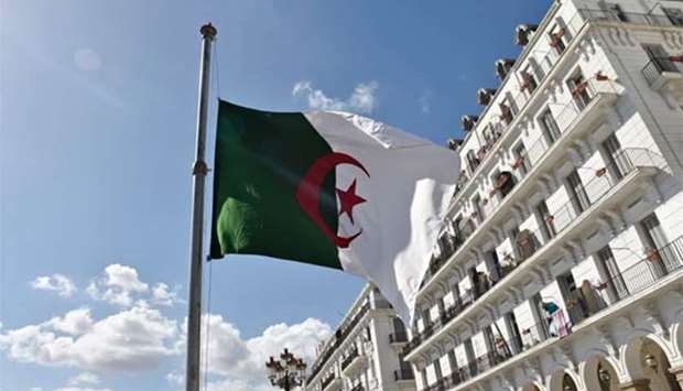 The Algerian flag is seen at half mast in Algiers on Thursday after the president declared three days of national mourning over a military plane crash in which 257 people were killed.