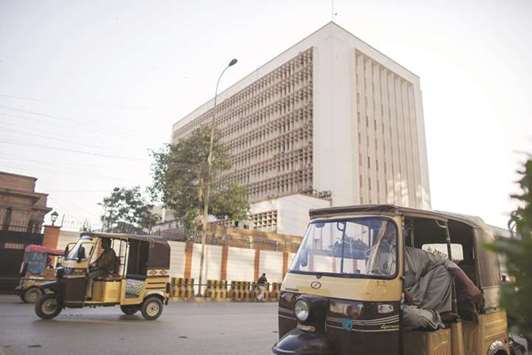 Auto rickshaws pass the State Bank of Pakistan building in Karachi. u201cIn order to further strengthen the trade channels and remittance flows in Chinese yuan, SBP has now allowed Bank of China (BoC) Pakistan to establish a local yuan settlement and clearing setup in Pakistan,u201d the State Bank of Pakistan said in a statement yesterday.