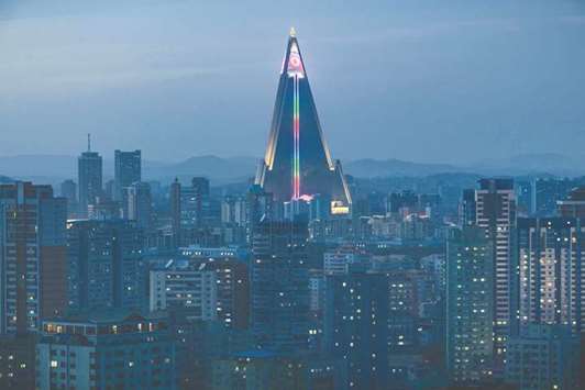 A North Korean flag is displayed in lights atop the empty Ryugyong hotel amid the Pyongyang city skyline yesterday. There has been no official word on any plans for the hotel u2013 although this weekendu2019s 106th anniversary of Kim Il-sungu2019s birth could be the occasion for some kind of unveiling.