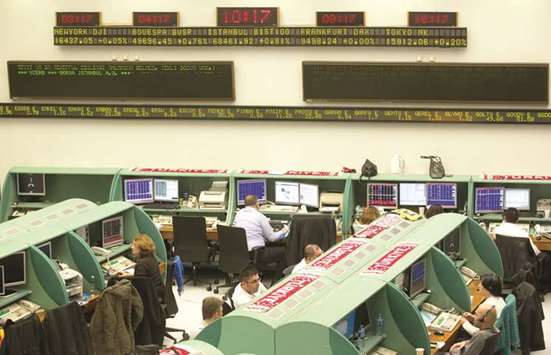 Traders work at their terminals beneath electronic ticker boards inside the Borsa Istanbul in Istanbul. Turkeyu2019s worst-performing equity fund of last year is leading the pack in 2018 as a strategy of targeting small- and mid-cap companies proves the best way to navigate a dismal first quarter for stocks.