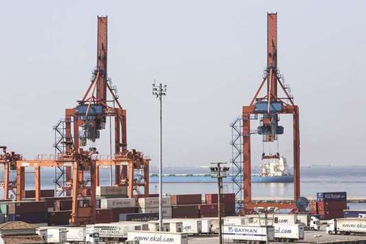 A cargo vessel passes gantry cranes and shipping containers at the Port of Haydarpasa, also known as Haidar Pasha, on the Bosporus strait, in Istanbul (file). Turkeyu2019s exports reached a record $15.1bn in March, Economy Minister Nihat Zeybekci said yesterday during a televised interview on private broadcaster CNNTurk.
