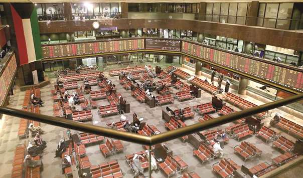 Kuwaiti traders follow the stock market at the Kuwait Stock Exchange (KSE) in Kuwait City (file). Six months ago, index compiler FTSE Russell classified the Gulf nation as an emerging market, with implementation starting in September.