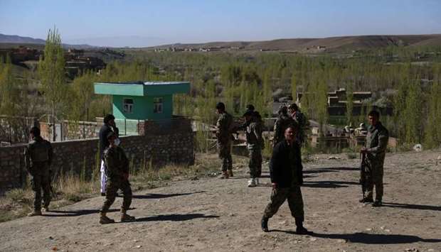 Afghan security personnel keep watch at the site of an attack by Taliban militants on a government compound in the Khwaja Omari district in the southeastern province of Ghazni yesterday.