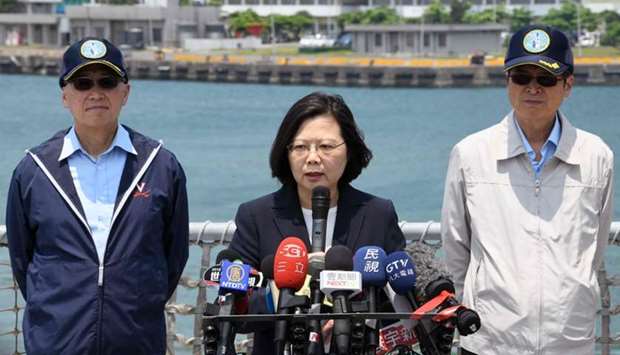 Taiwan President Tsai Ing-wen (C) speaks as David Lee, Chief of Taiwan's National Security Council (L) and Yen Teh-fa, Defense Minister stand behind at the Suao navy harbour in Yilan, eastern Taiwan.