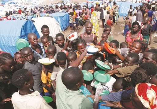 People wait for food distribution at an internally displaced persons (IDP) camp in Bunia, Ituri province, eastern Democratic Republic of the Congo.