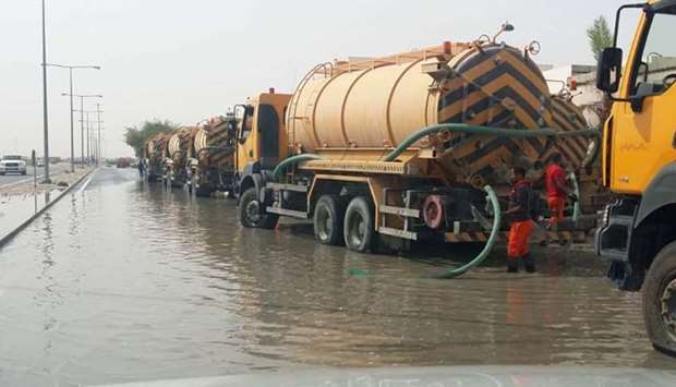 Tankers engaged in removing rainwater from a street.rnrn