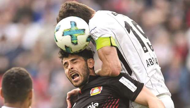 Frankfurtu2019s Argentinian defender David Abraham (R) and Leverkusenu2019s German forward Kevin Volland vie for the ball  during their Bundesliga match in Leverkusen, western Germany, yesterday.