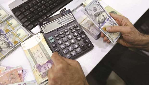 A close-up shot of Iranians trading money at a currency exchange office in a shopping centre in the capital Tehran on Tuesday. As Iranu2019s confrontation with the Trump administration and US regional allies heats up, its rulers are attempting to avert a currency crisis that would add to their domestic woes.