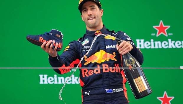 Red Bull's Daniel Ricciardo with champagne and a shoe as he celebrates winning the race.