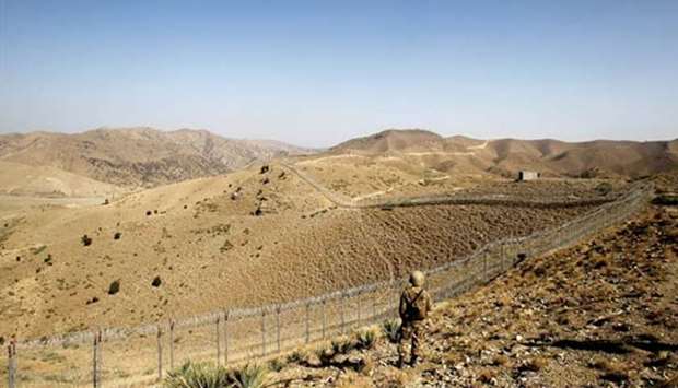 A soldier stands guard along the border fence outside the Kitton outpost on the border with Afghanistan in North Waziristan, Pakistan. File picture