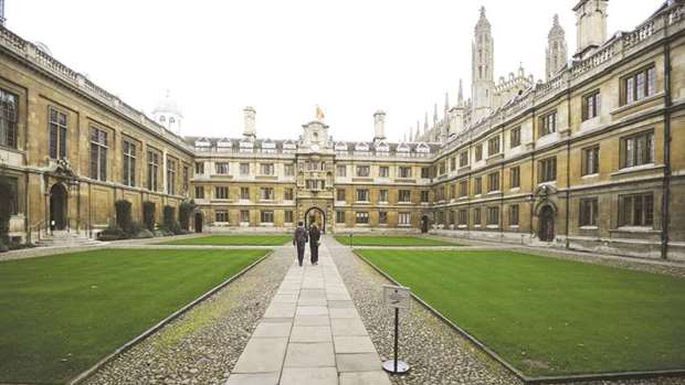 People walk through Clare College at Cambridge University in eastern England. The elite 800-year-old British university said in a statement that it would be u201csurprisedu201d if Zuckerberg had only just become aware that a number of its academics had been researching what a personu2019s Facebook data says about their personality.