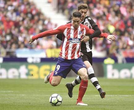 Atletico Madridu2019s Fernando Torres (left) vies with Levanteu2019s Jose Campana during the Spanish La Liga in Madrid yesterday. (AFP)